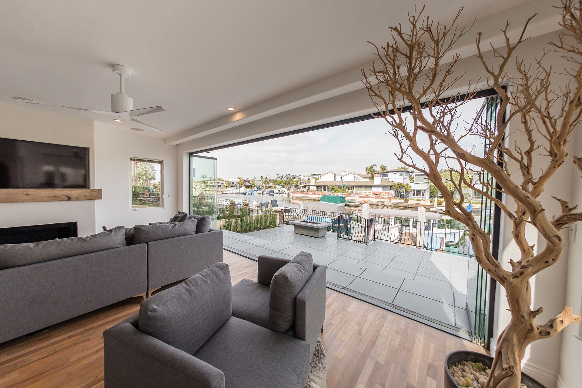 Living room with frameless sliding glass doors and patio.