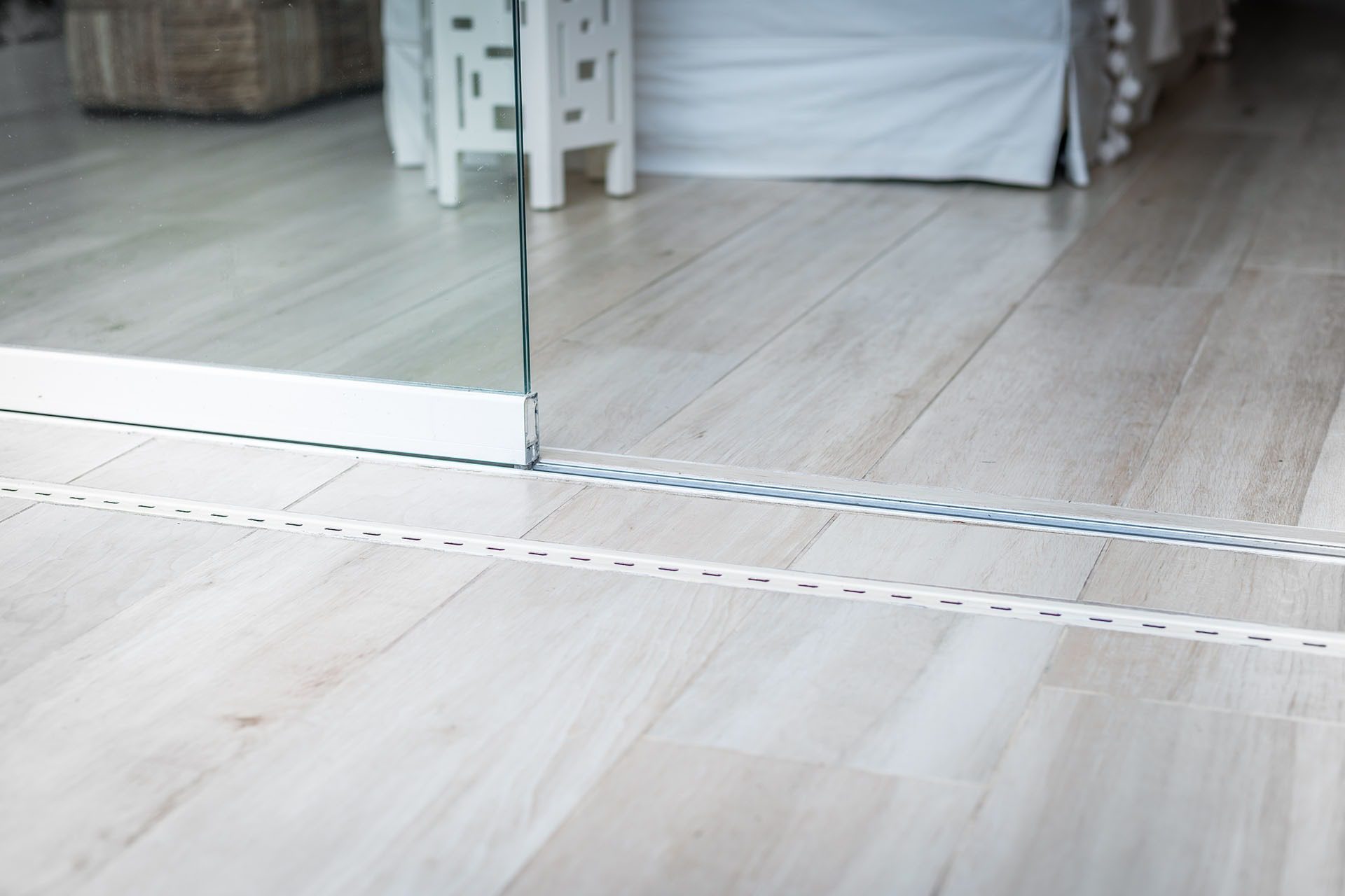 Track of frameless sliding glass doors.