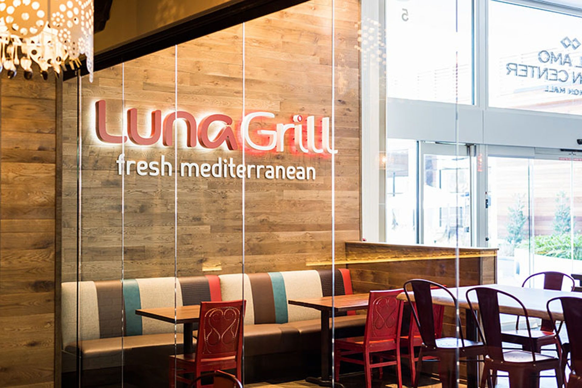 Closed frameless sliding glass doors inside restaurant.