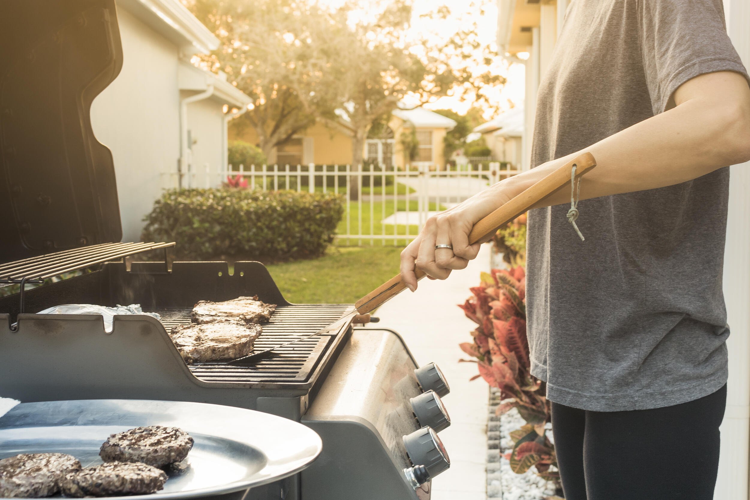 A man cooking outside in summer